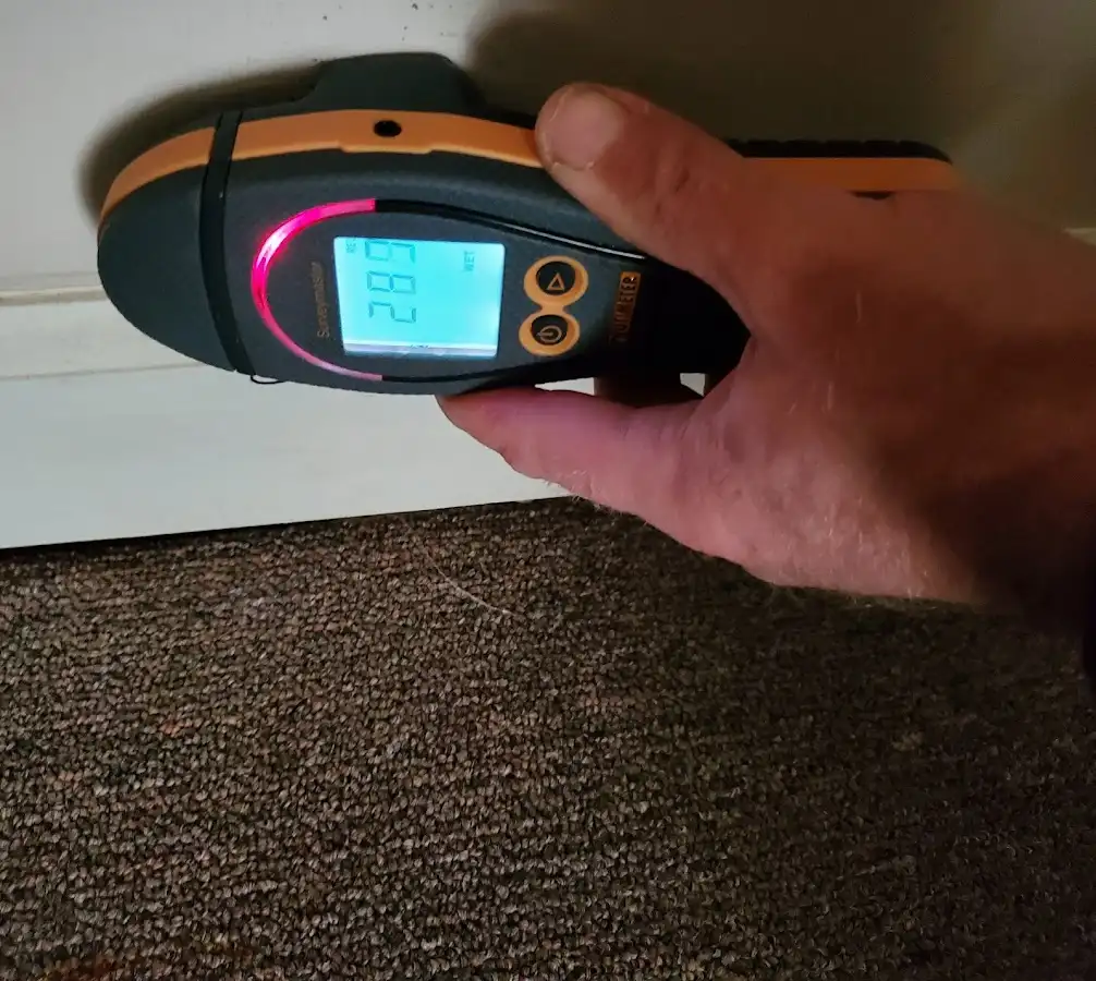 Moisture detection at baseboard during Storm Damage Restoration in Ada